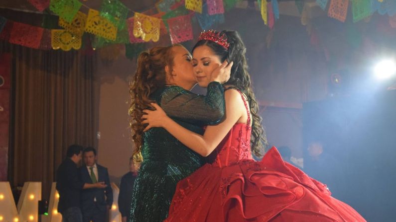 Bertha Sanchez embraces her daughter Madeline Sanchez during a dance halfway through the ceremony celebrating Madeline’s coming-to-age. (Dante Filpula Ankney / KHOL)