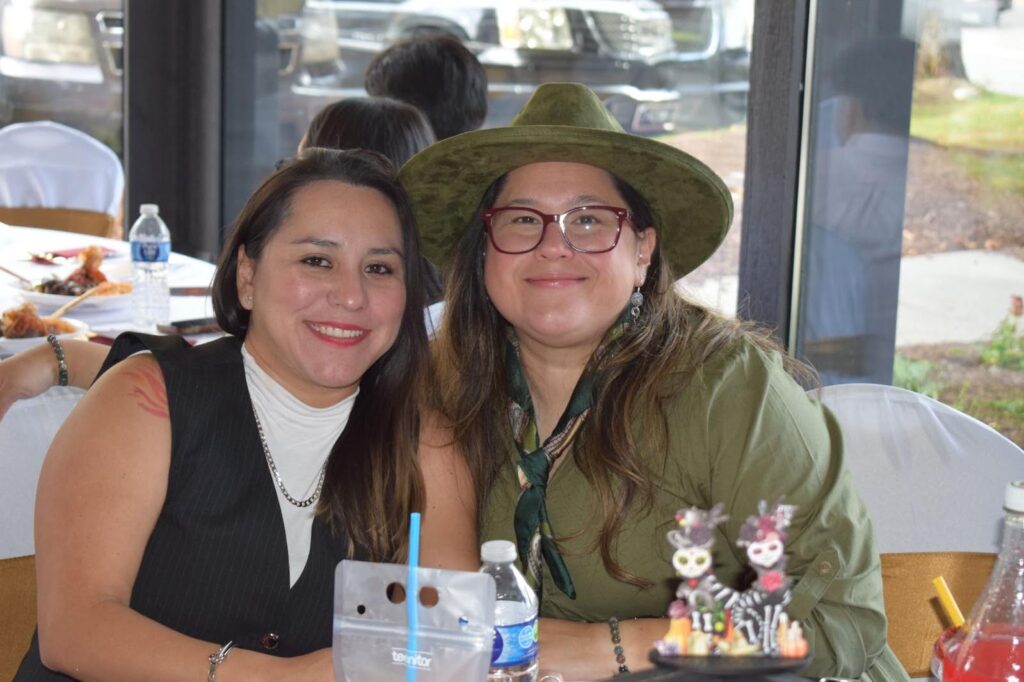 Martha Herrera (left) and Andrea Bulanos (right) have lived in Jackson for years, working in food service. They helped set up the night before and say parties like this are frequent in Jackson, but that’s not the case in Mexico. (Dante Filpula Ankney / KHOL)