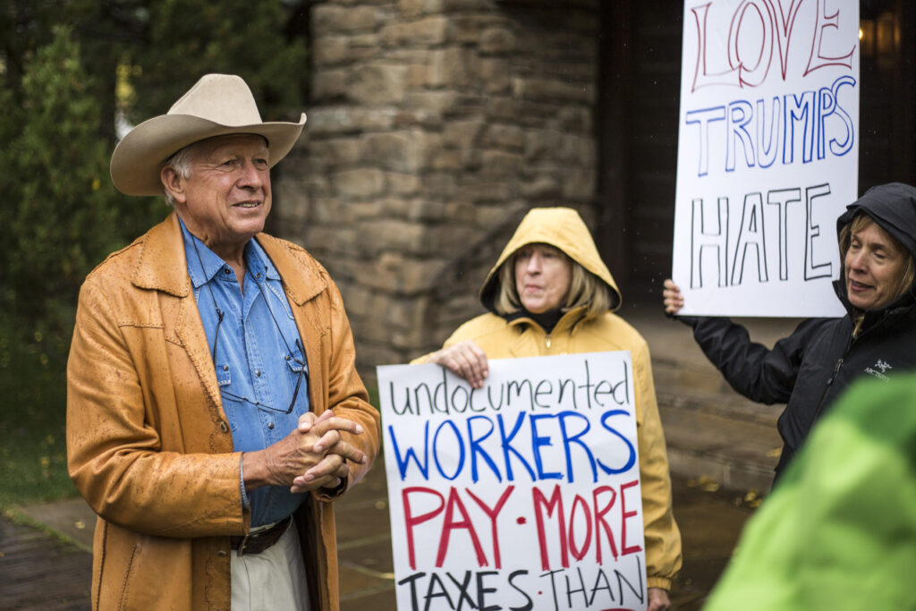 Foster Friess speaks in 2016 with protestors opposed to a fundraiser for the Trump Victory Fund. Friess was the Cowboy State Daily’s initial financial backer. (Ryan Dorgan/Jackson Hole News&Guide)