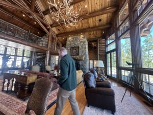 Greg Mezak searches for defects in a luxury home in Wilson. He said properties will continue to rent for tens of thousands a week as tourists flock to Jackson Hole for recreation and wildlife, bolstering many of the same industries they strain. (Evan Robinson-Johnson / KHOL)